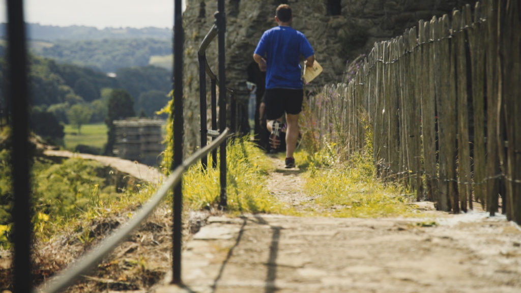 Man running along castle walls