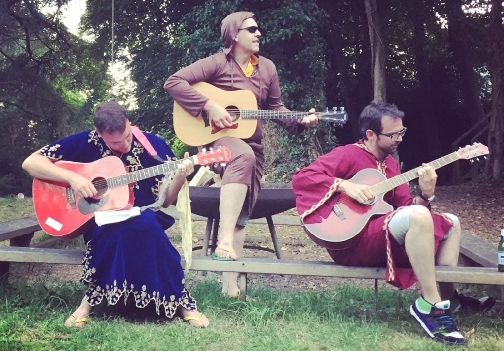Three guitarists in medieval dress